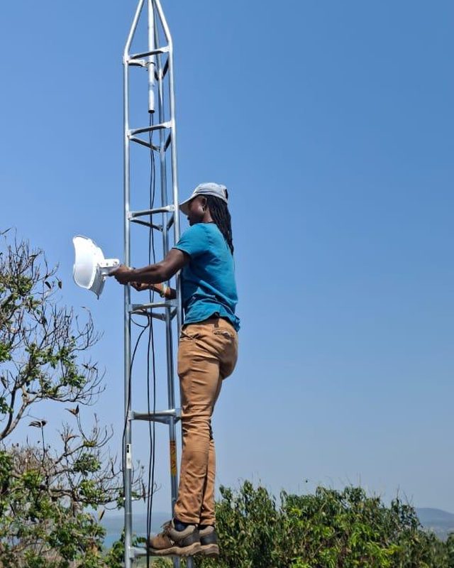 A customer dish being mounted on a mast in Nkomazi